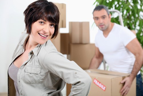 Professional movers handling furniture and boxes inside a Belmont property