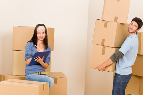 Careful loading of household items by a man and van service in Belmont